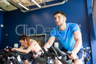 Man and woman using cycling exercise bikes