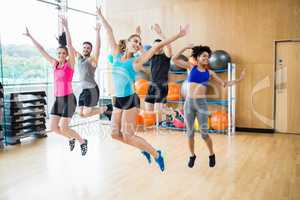 Fitness class jumping up in studio