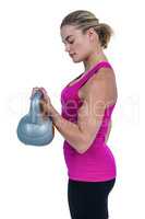 Muscular woman exercising with kettlebell
