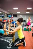 Fit people working out in weights room