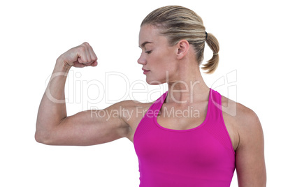 MId section of muscular woman flexing muscle