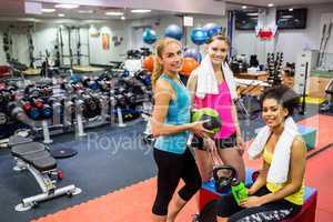 Fit women smiling in weights room
