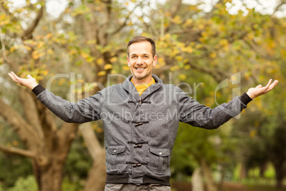 Young handsome man with raised arms