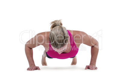 Portrait of pretty woman doing push ups