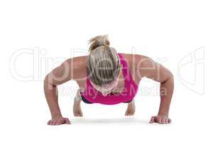 Portrait of pretty woman doing push ups