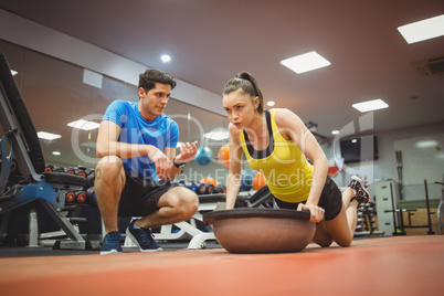 Fit woman working out with trainer