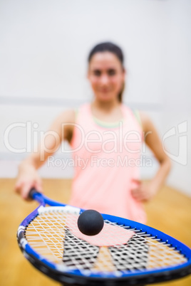 Woman balancing a ball on her racket