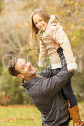 Happy father carrying his cute daughter