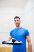 Man balancing a ball on his racket
