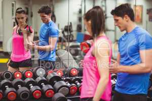 Fit couple working out in weights room