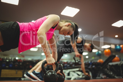 Fit couple working out in weights room