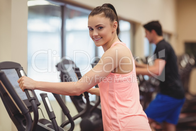 Fit people working out using machines