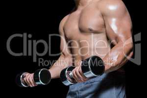 Mid section of a bodybuilder with dumbbells