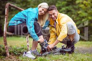 Happy couple putting on roller blades