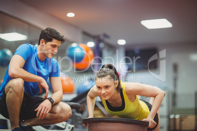 Fit woman working out with trainer