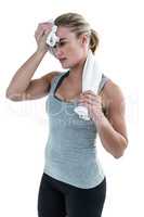 Muscular woman wiping herself with towel