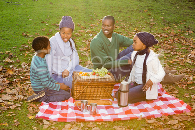 Happy family picnicking in the park together