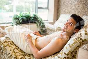 Handsome man relaxing in thermal suite