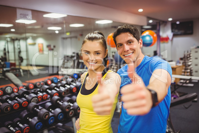 Fit couple smiling at camera