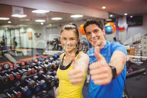 Fit couple smiling at camera