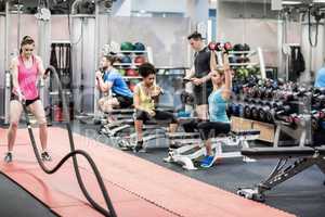 Fit people working out in weights room