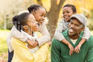 Portrait of a young smiling family in piggyback