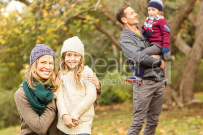 Smiling woman with her daughter against her husband and her son