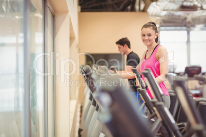 Fit people working out using machines