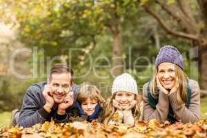 Smiling young family with hands on cheeks