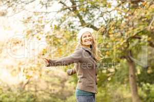 Smiling woman with arms outstretched