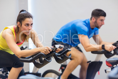 Couple using exercise bikes together