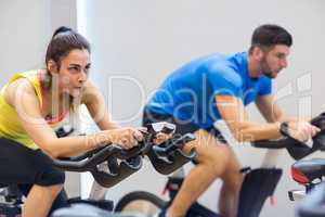 Couple using exercise bikes together