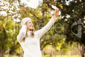 Smiling pretty woman taking selfies