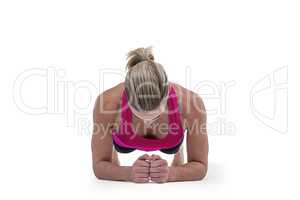 A muscular woman on a plank position