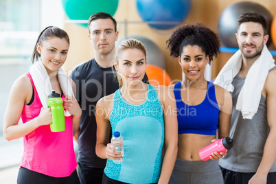 Fitness class smiling at camera in studio