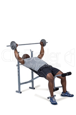 Fit man exercising with barbell