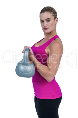 Muscular woman exercising with kettlebell