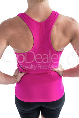 Rear view of muscular woman with hands hips
