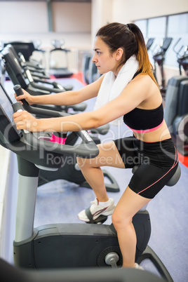 Focused woman using the exercise bike