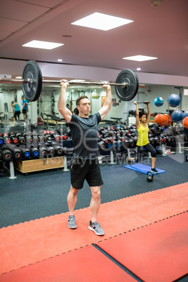 Fit man working out in weights room