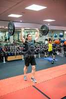 Fit man working out in weights room