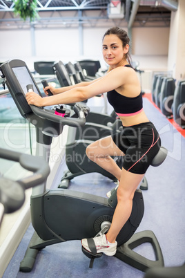 Smiling woman on the exercise bike