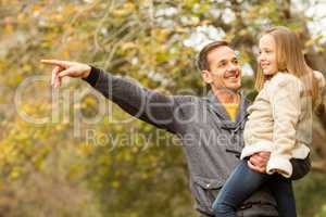 Father showing something to his smiling daughter