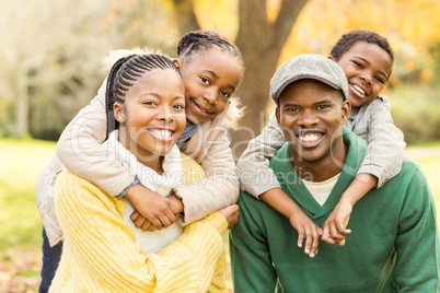 Portrait of a young smiling family in piggyback