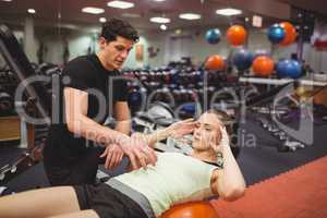 Fit woman working out with trainer