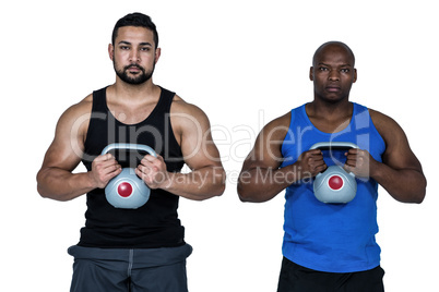 Strong friends lifting kettlebells together