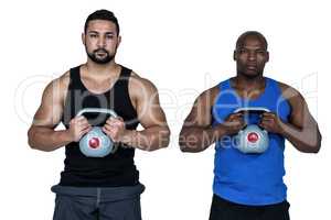 Strong friends lifting kettlebells together
