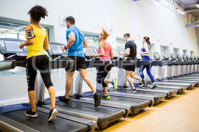 Fit people jogging on treadmills