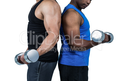 Strong friends posing with dumbbells