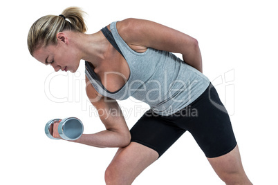 Muscular woman working out with dumbbells